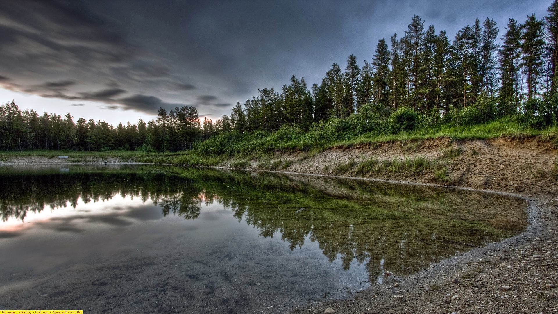 Stormy lake with forest reflection
