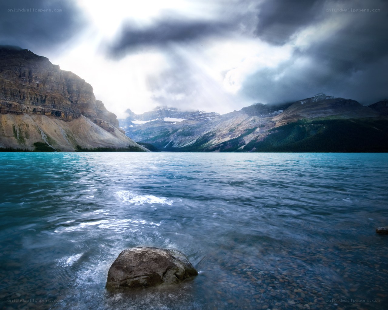Stormy lake with mountain backdrop