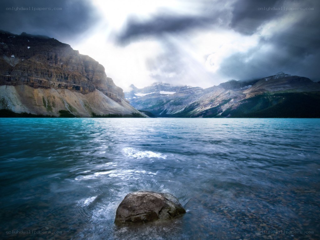 Stormy lake with mountain backdrop
