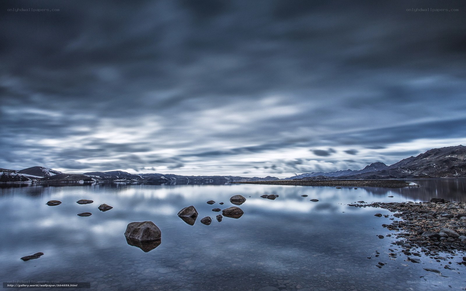 Stormy lake with mountain reflections