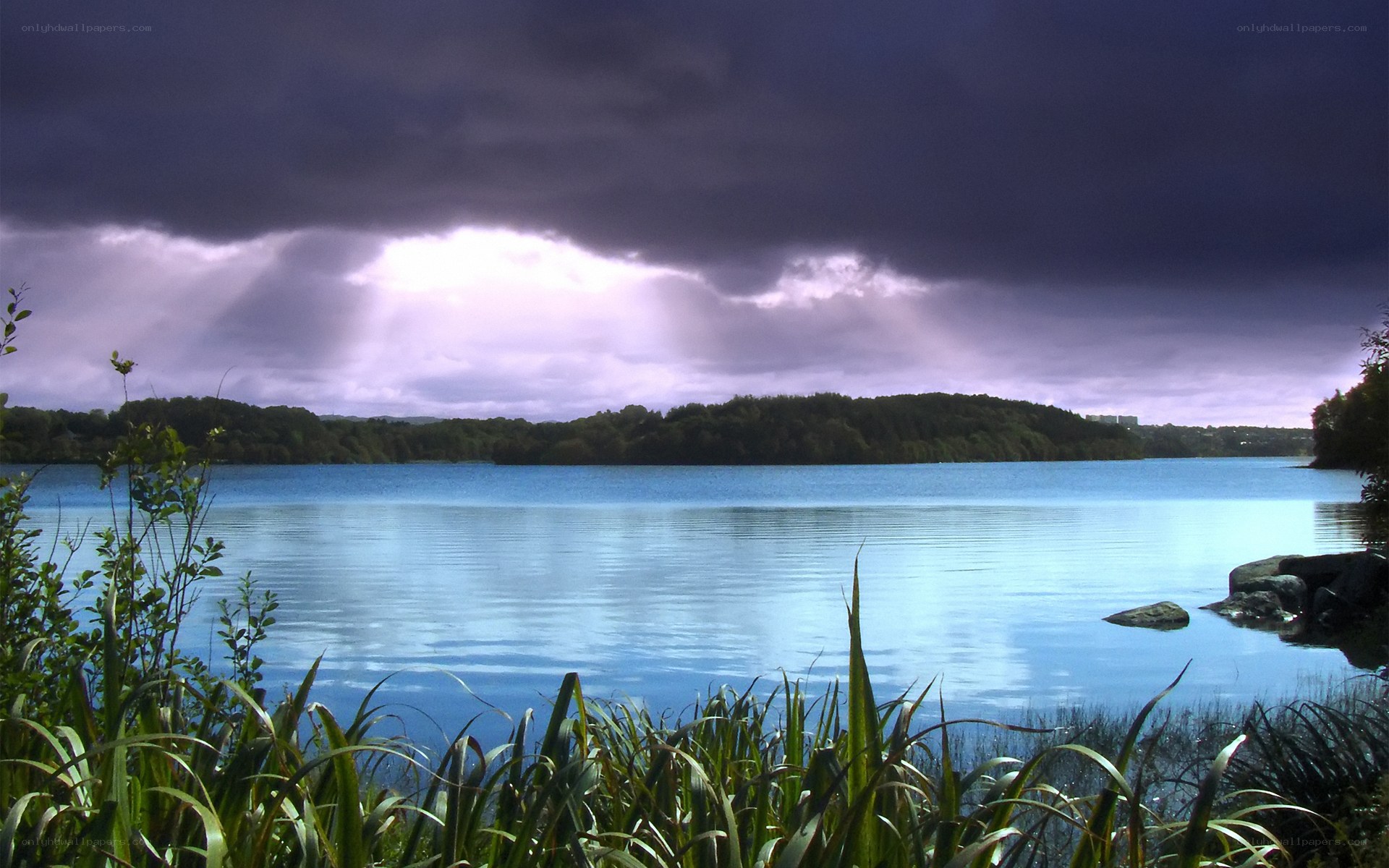 Stormy lake with sunbeams