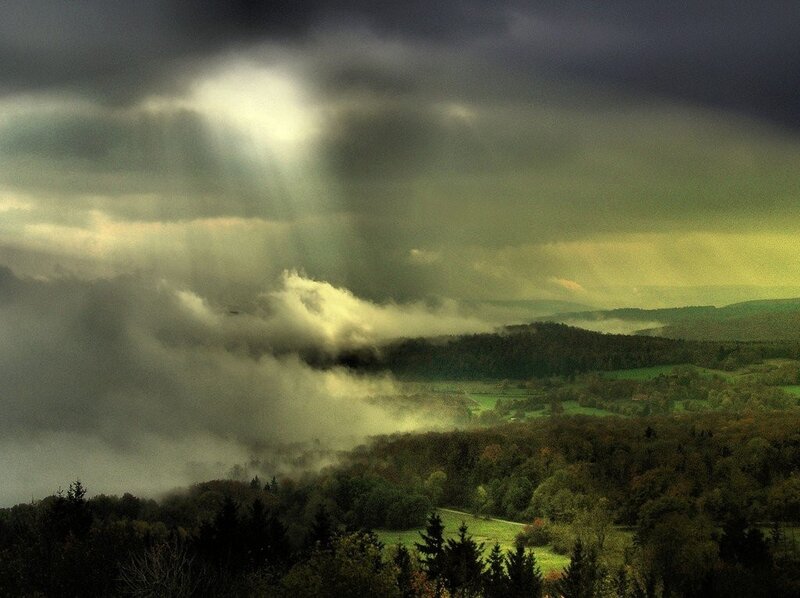Stormy landscape with sunbeams
