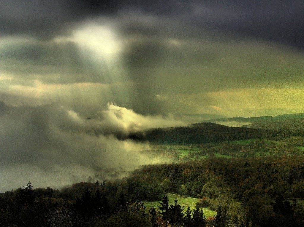 Stormy landscape with sunbeams