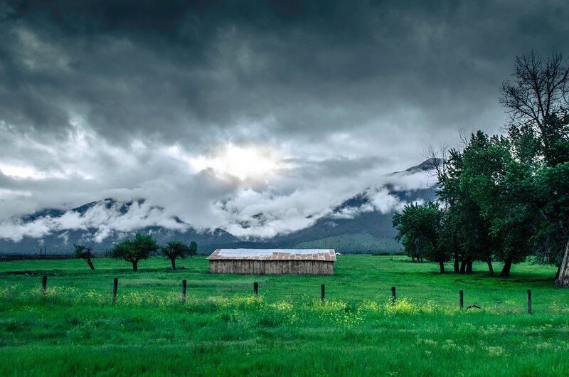 Stormy mountain farm scene