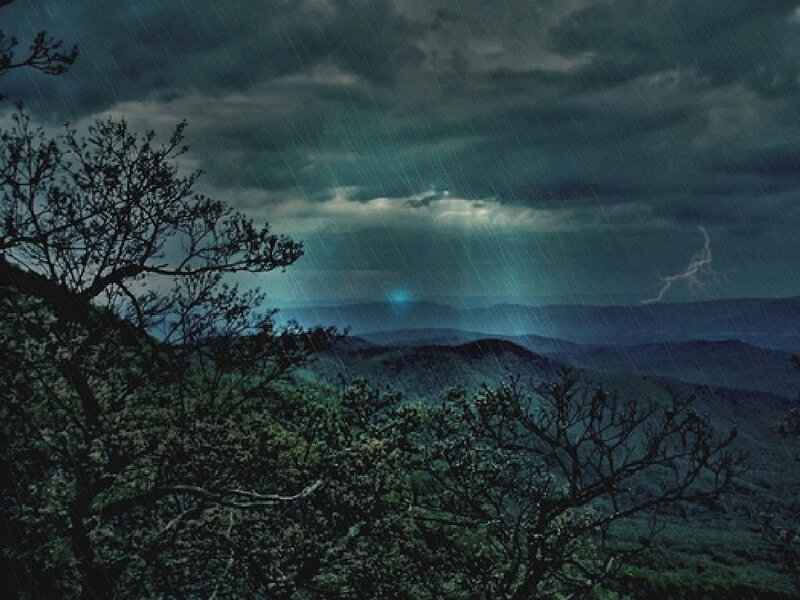 Stormy mountain landscape at night
