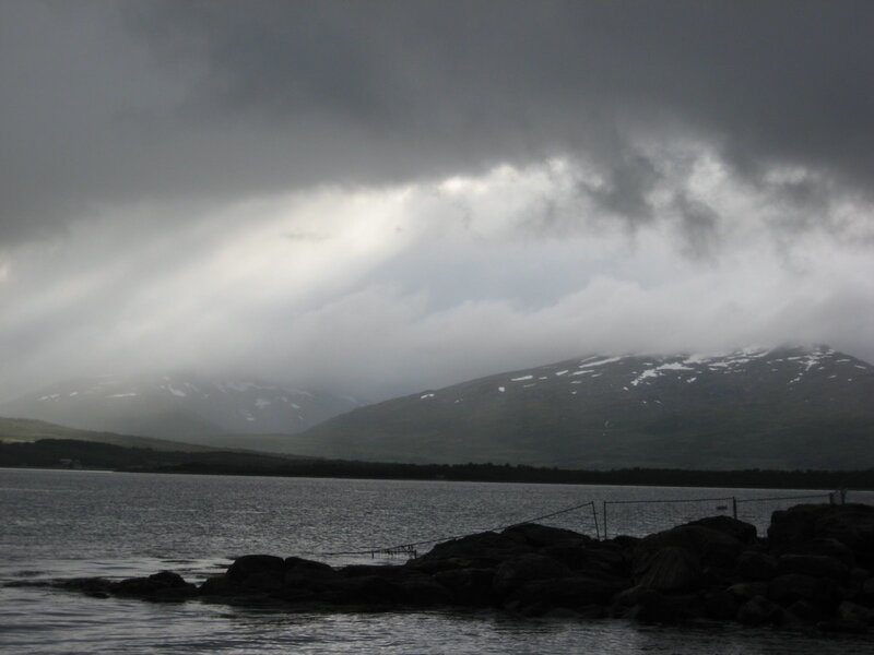 Stormy mountains over a lake
