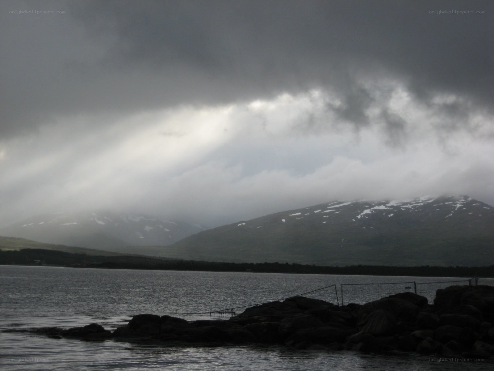 Stormy mountains over a lake