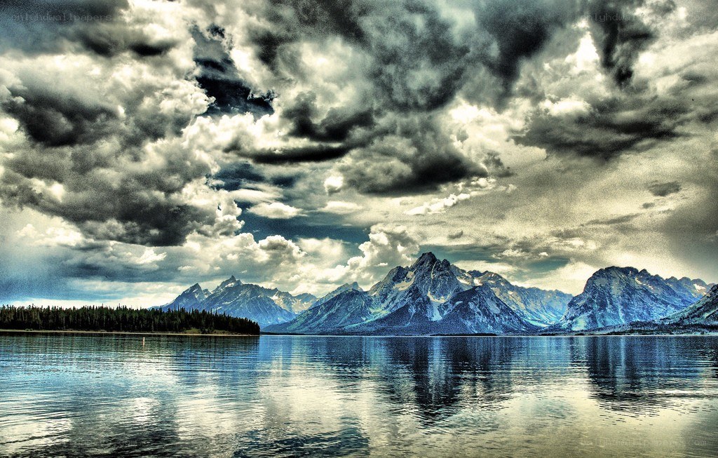 Stormy mountains reflected in a lake
