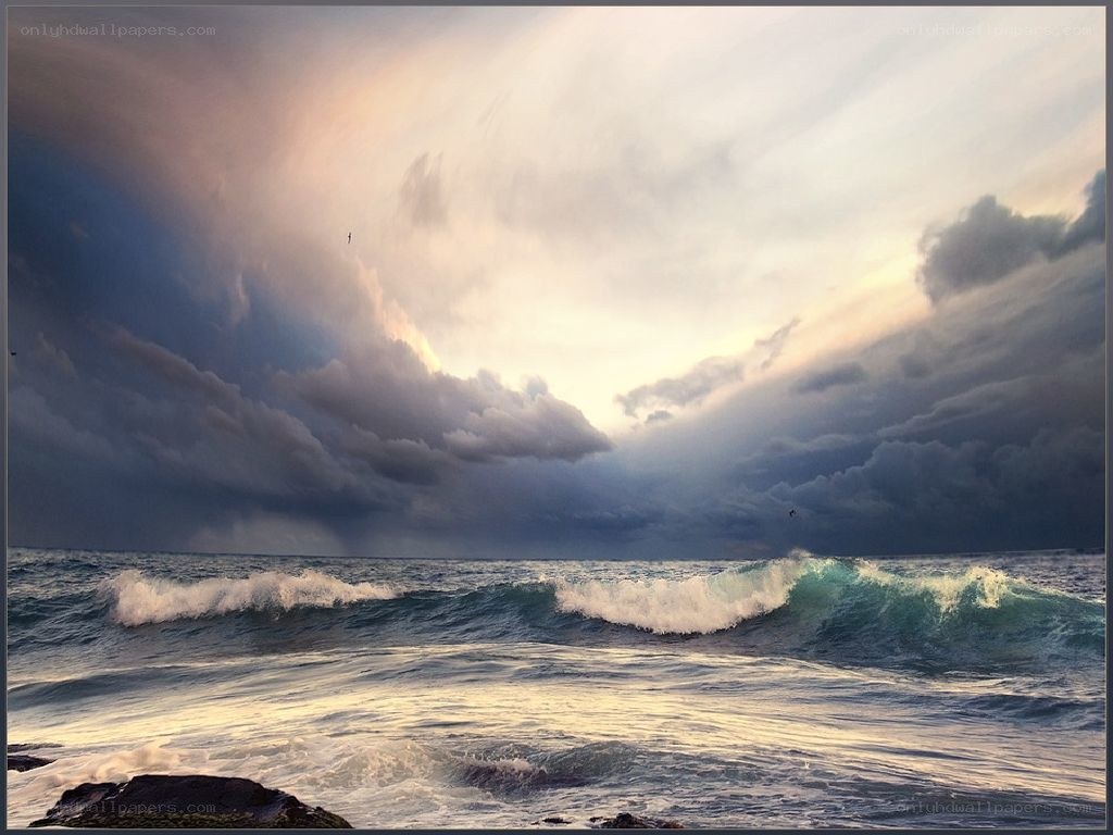 Stormy ocean waves at sunset