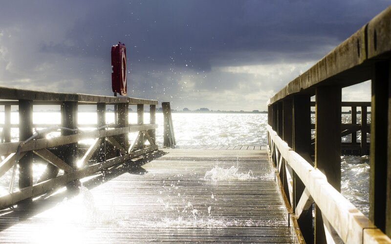 Stormy pier with splashing waves