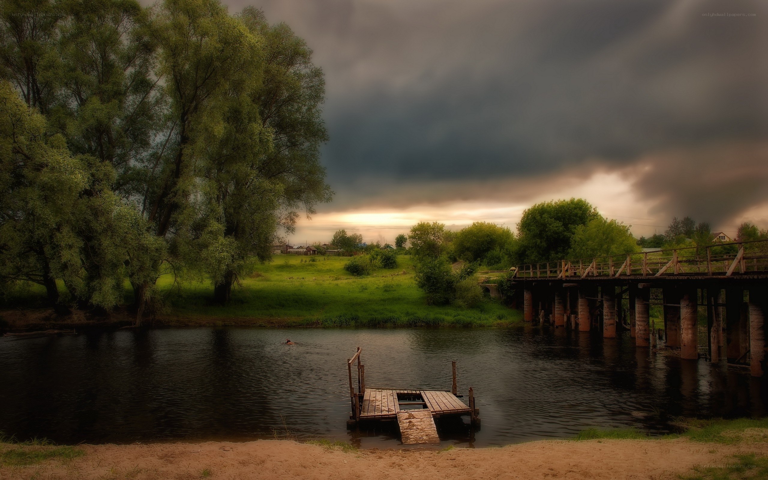 Stormy river with wooden bridge