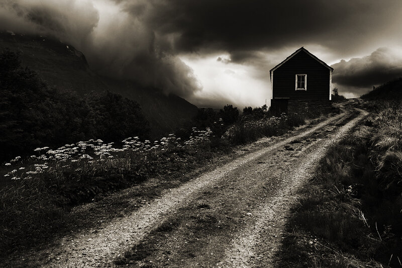 Stormy road to a solitary cabin