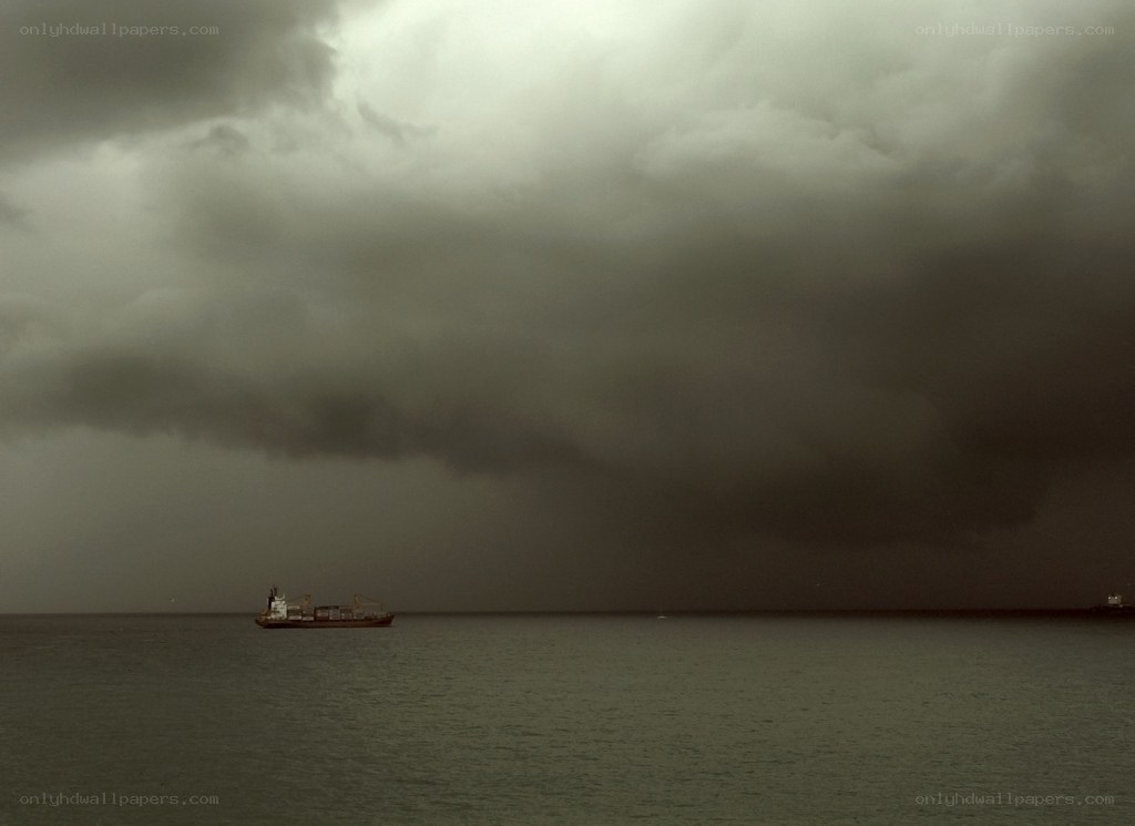 Stormy sea with cargo ship