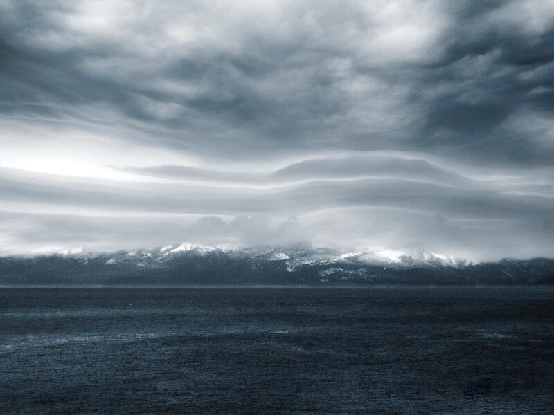 Stormy sea with snow-capped mountains