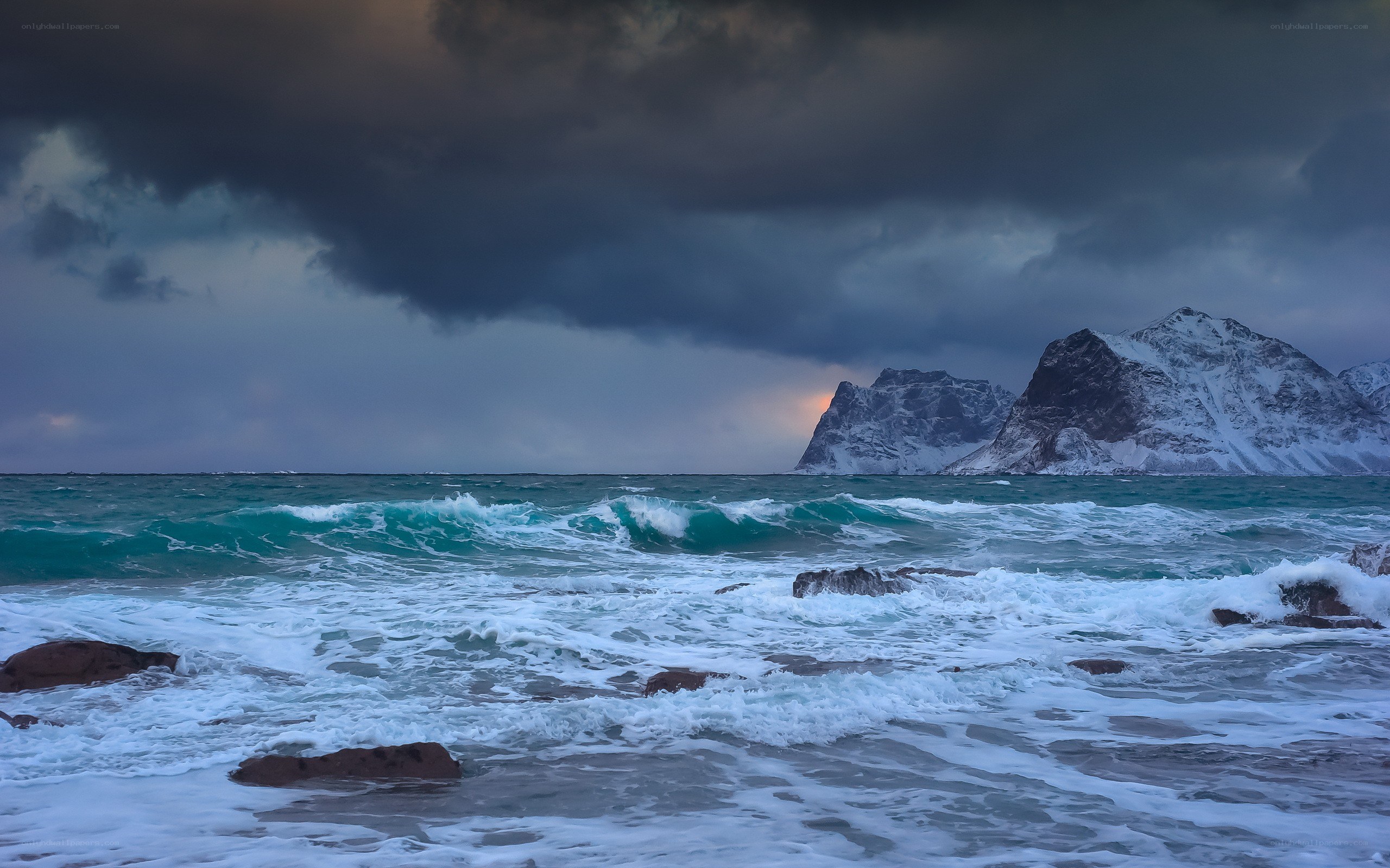 Stormy sea with snowy mountains