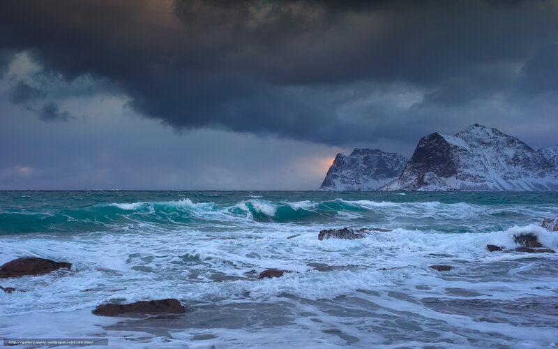 Stormy sea with snowy mountains