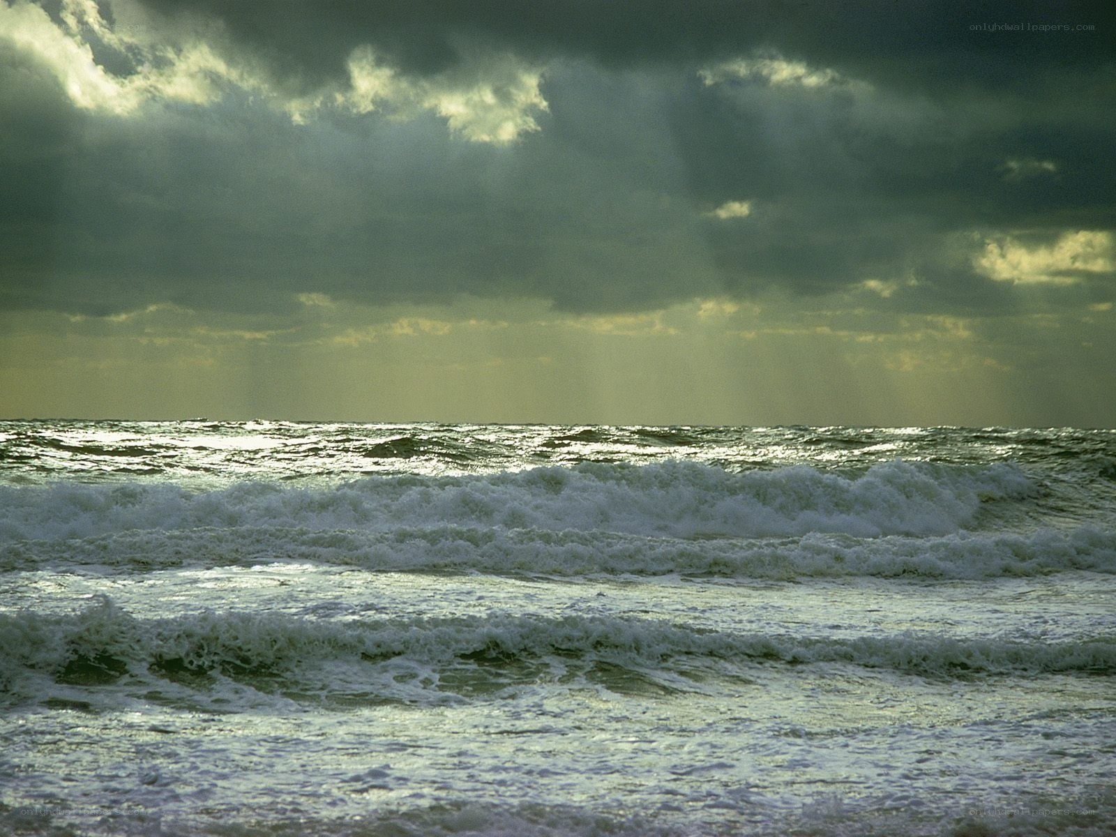 Stormy sea with sunbeams