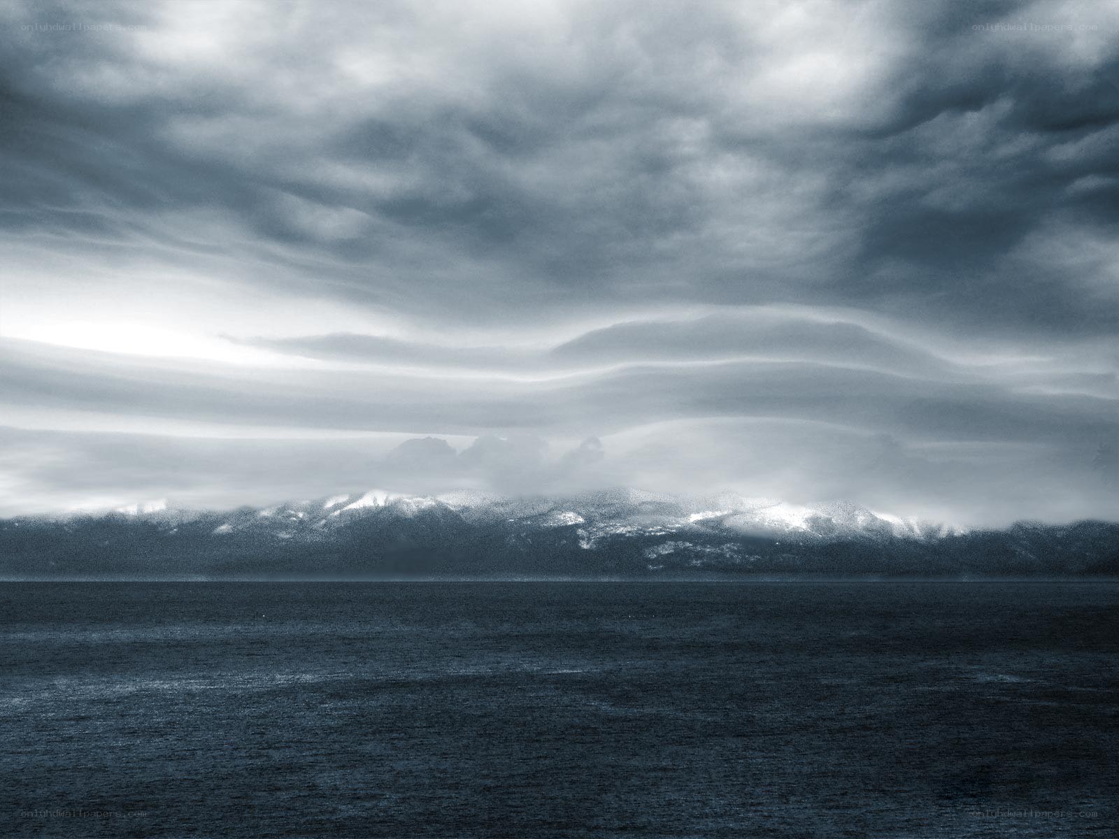 Stormy seascape with distant mountains