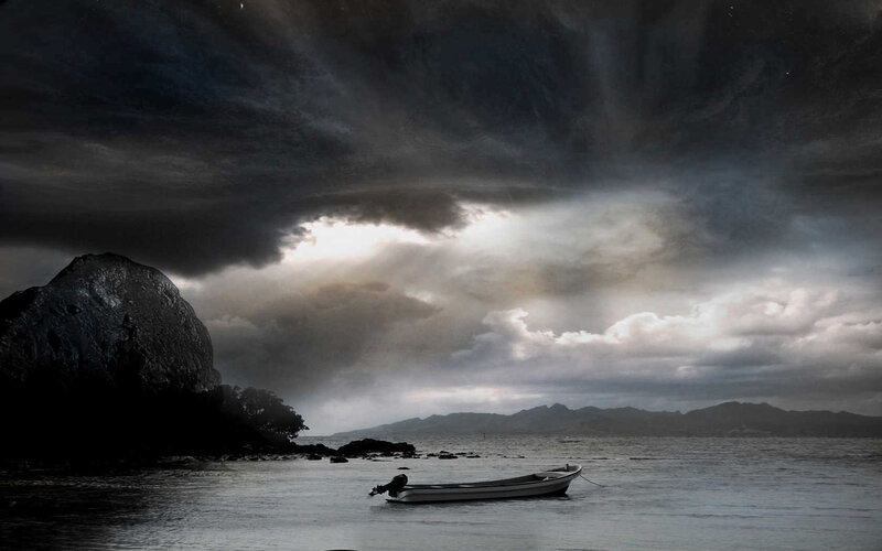 Stormy seascape with small boat