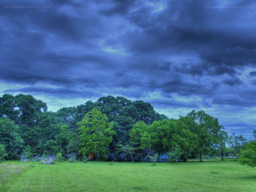 Stormy sky over a green field