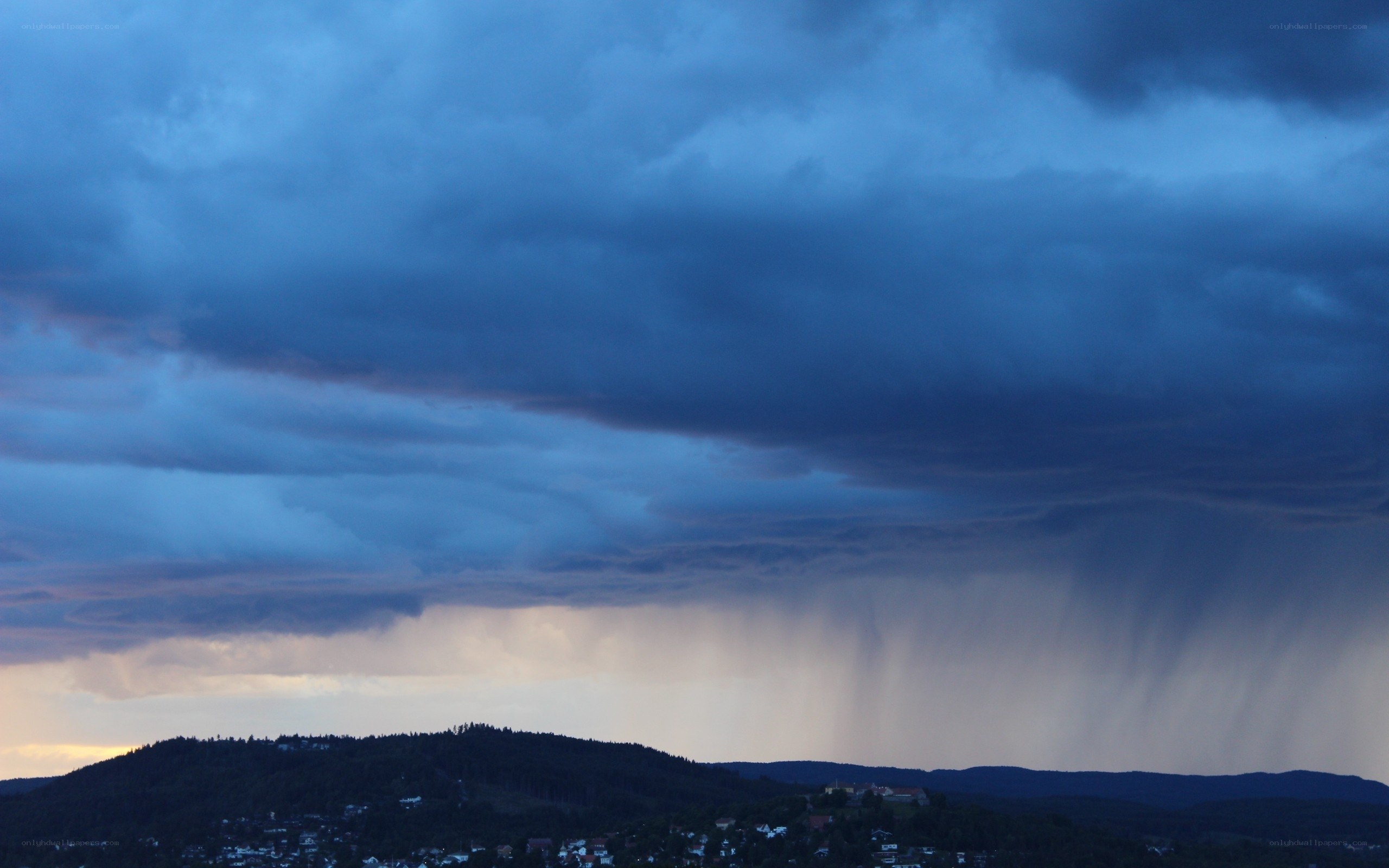 Stormy sky over a hillside town