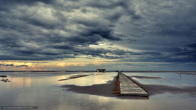 Stormy sky over a long pier