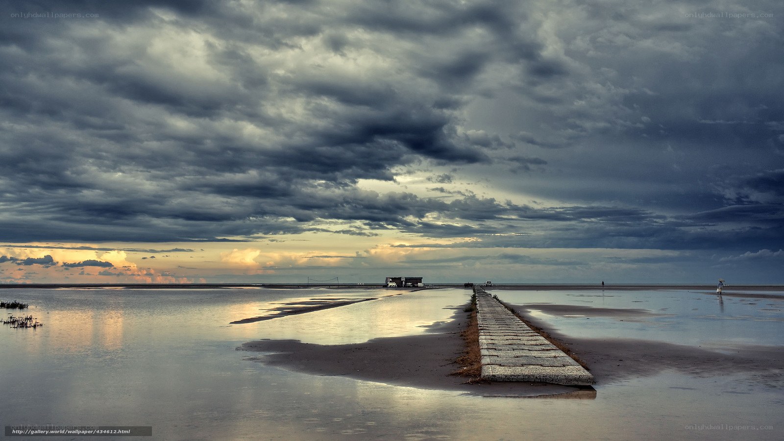 Stormy sky over a long pier