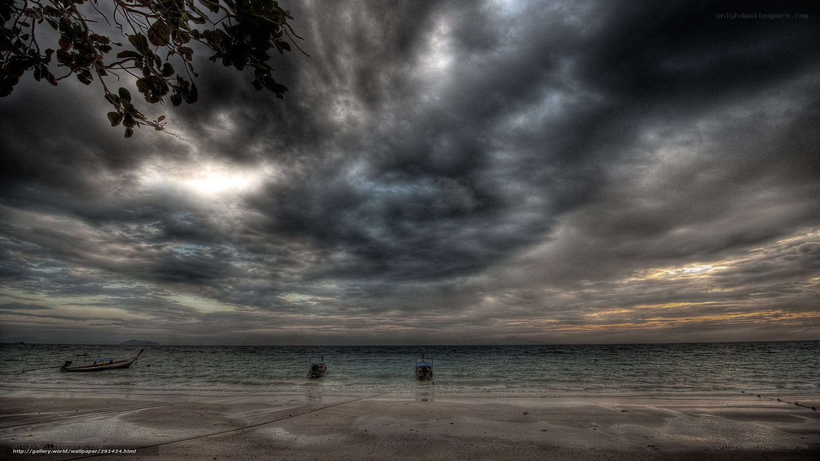 Stormy sky over beach with boats