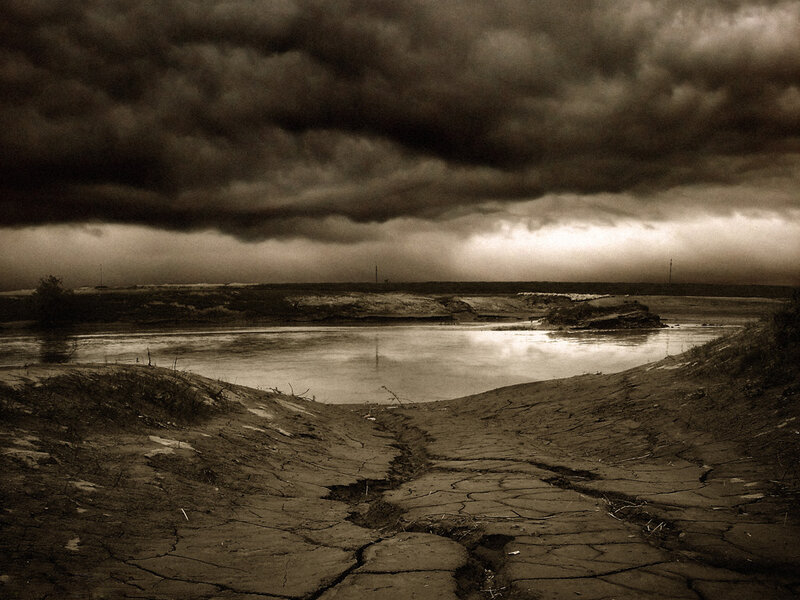 Stormy sky over cracked earth