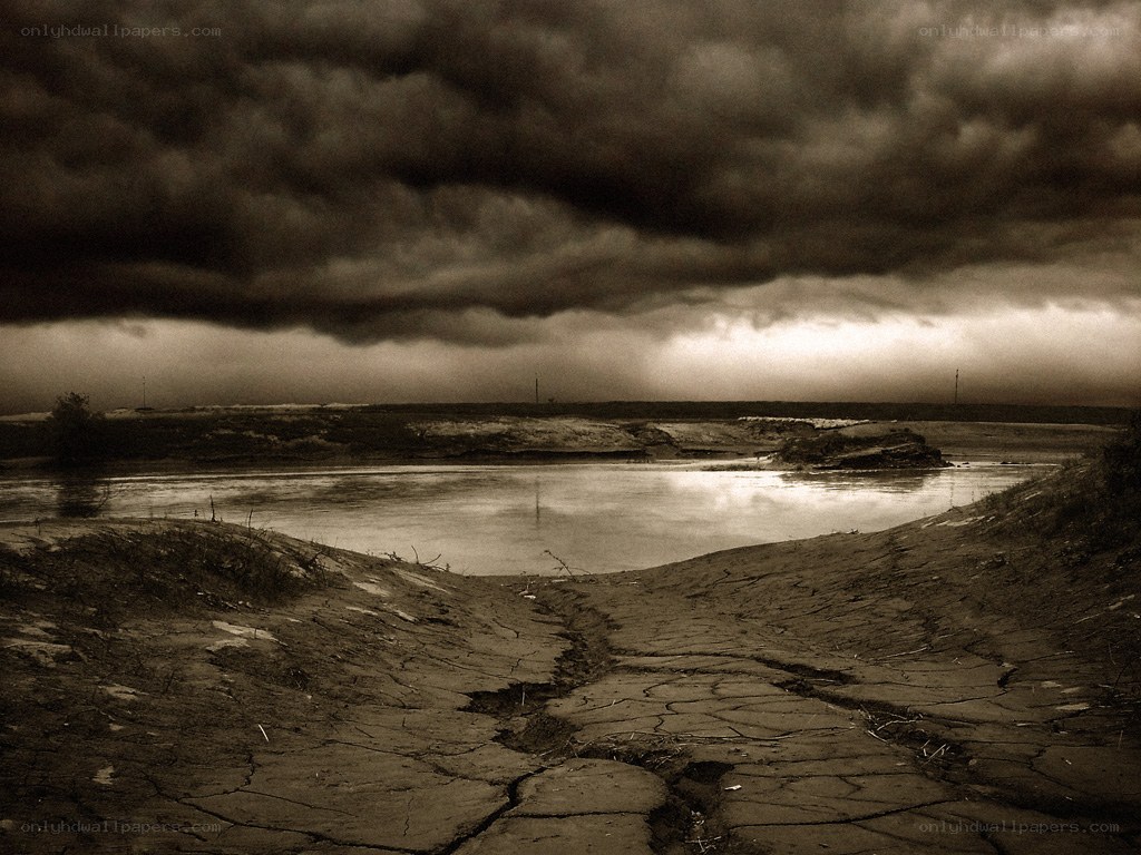 Stormy sky over cracked earth