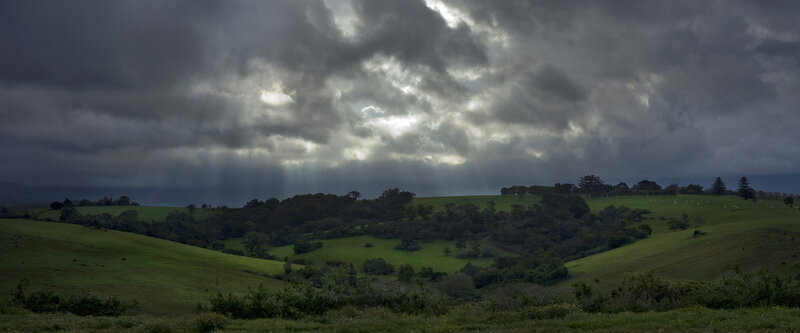 Stormy sky over green hills