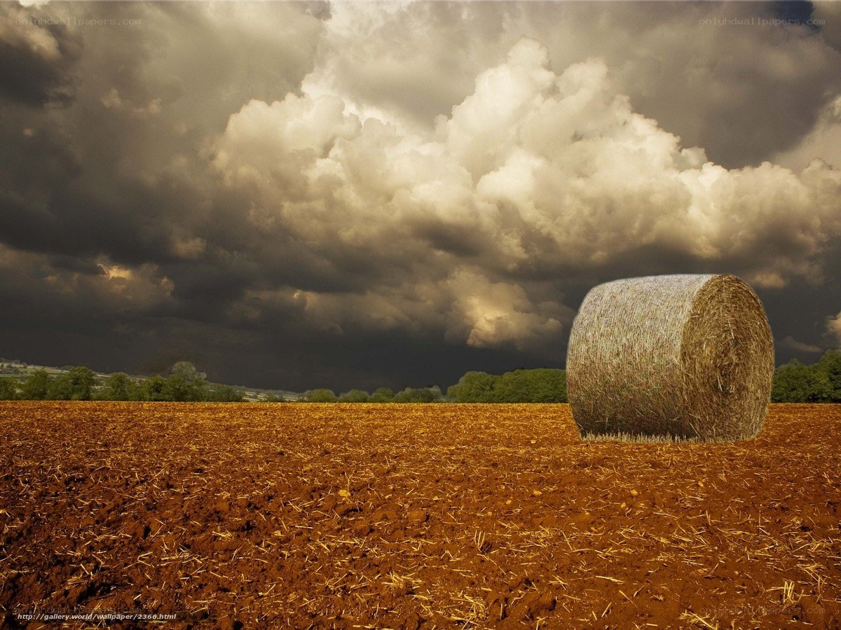 Stormy sky over hay bale