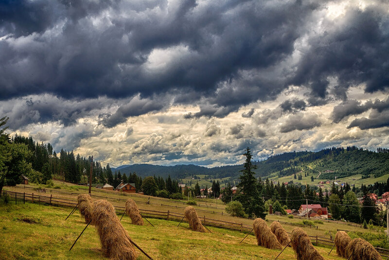 Stormy sky over hay bales
