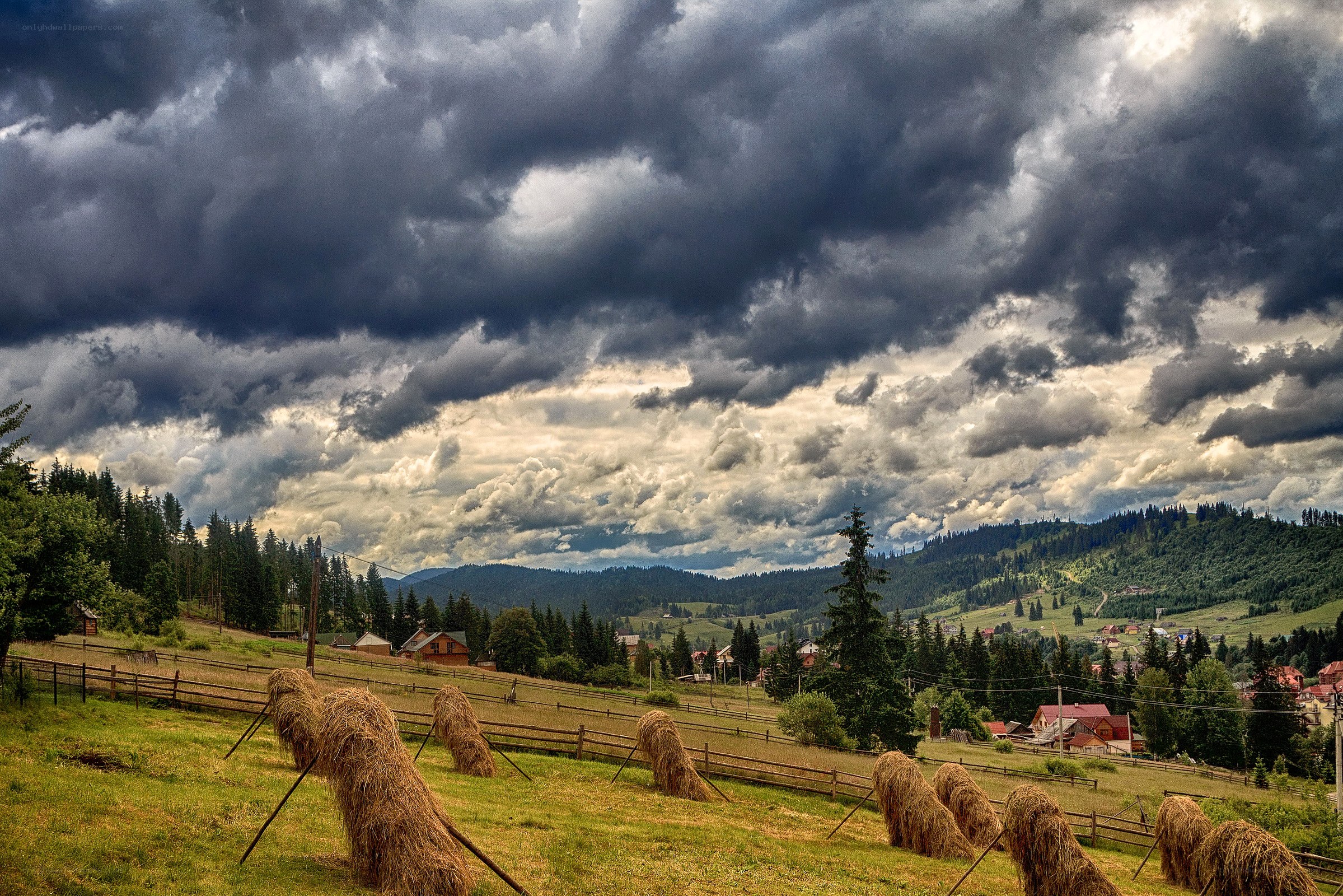 Stormy sky over hay bales