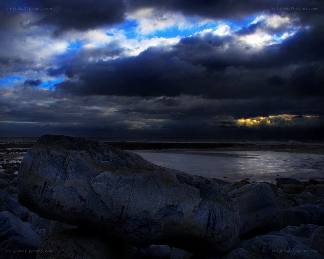 Stormy sky over rocky beach