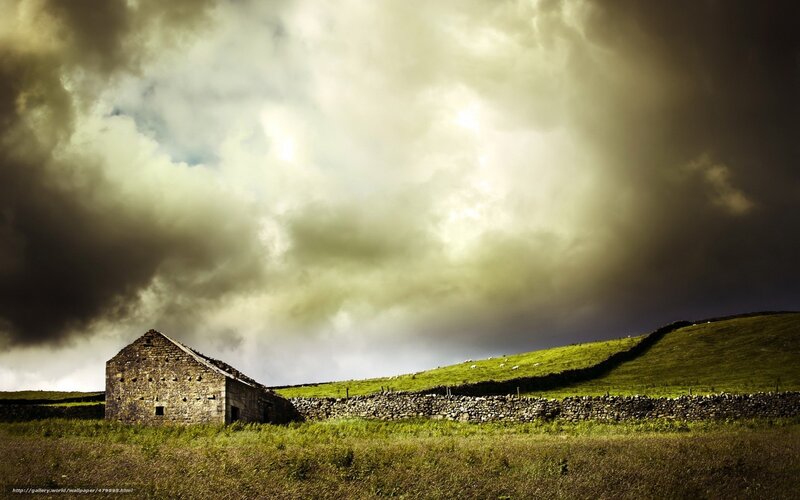 Stormy sky over stone barn