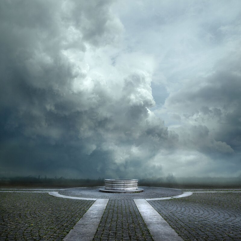 Stormy sky over stone well