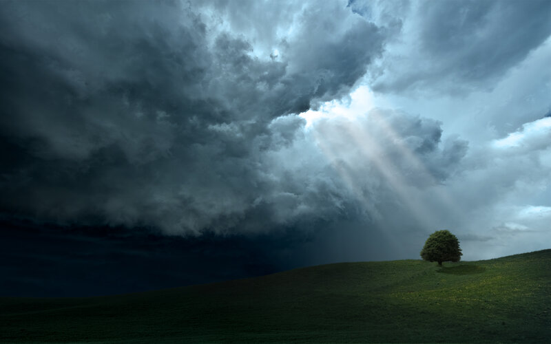Stormy sky with sunbeams