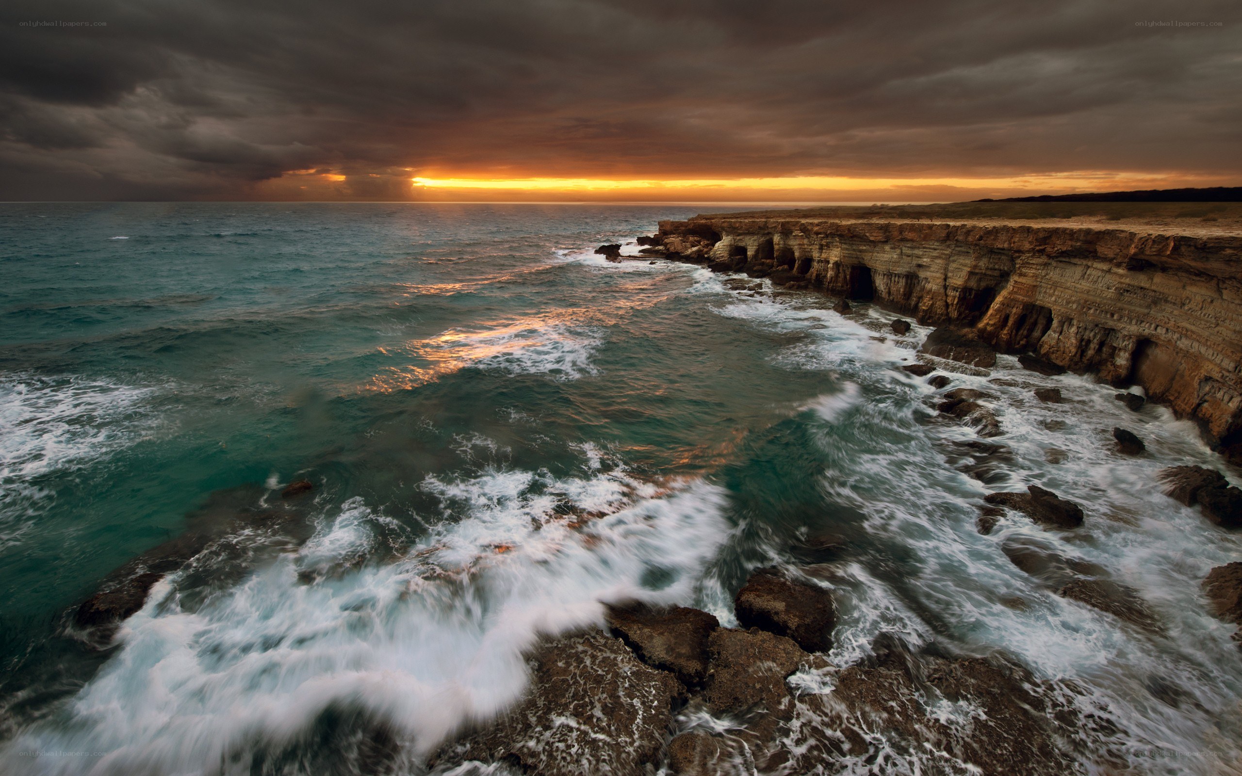 Stormy sunset at coastal cliffs