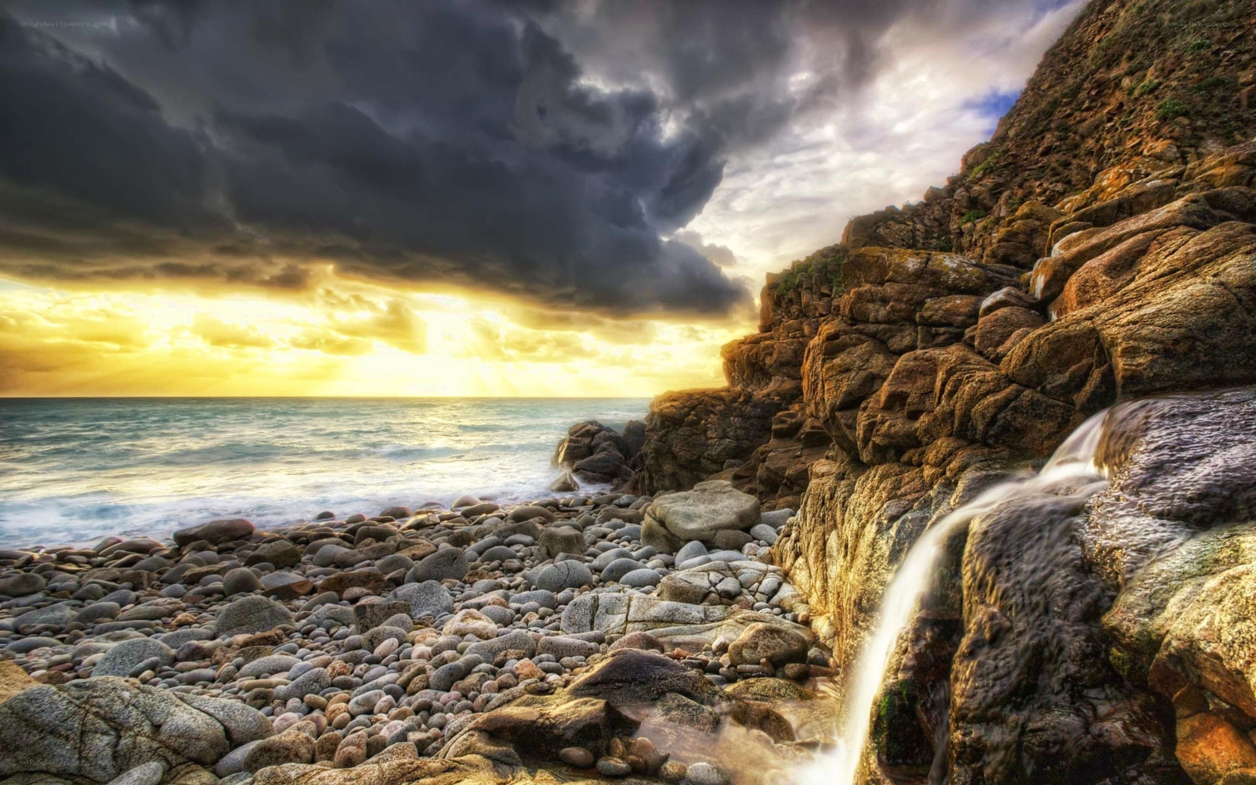 Stormy sunset at rocky beach