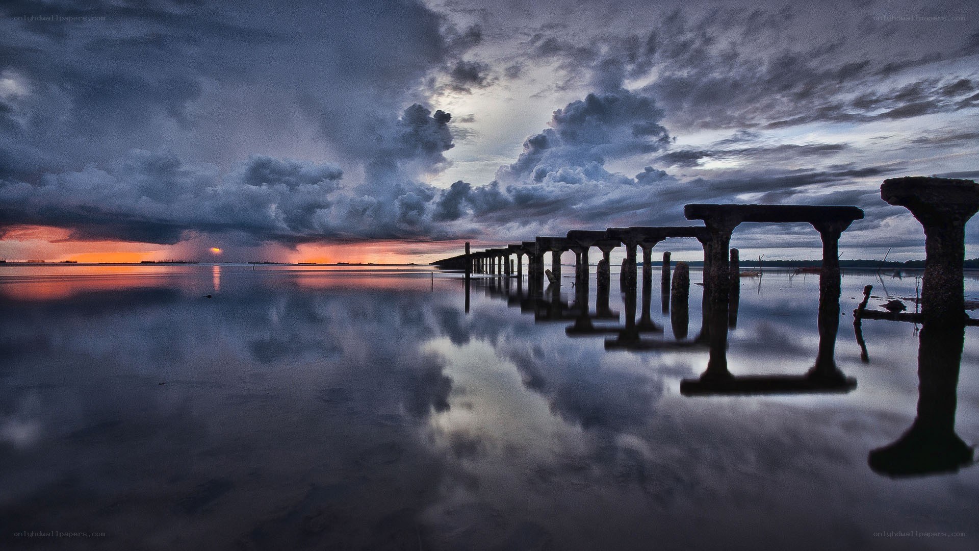 Stormy sunset over a ruined pier