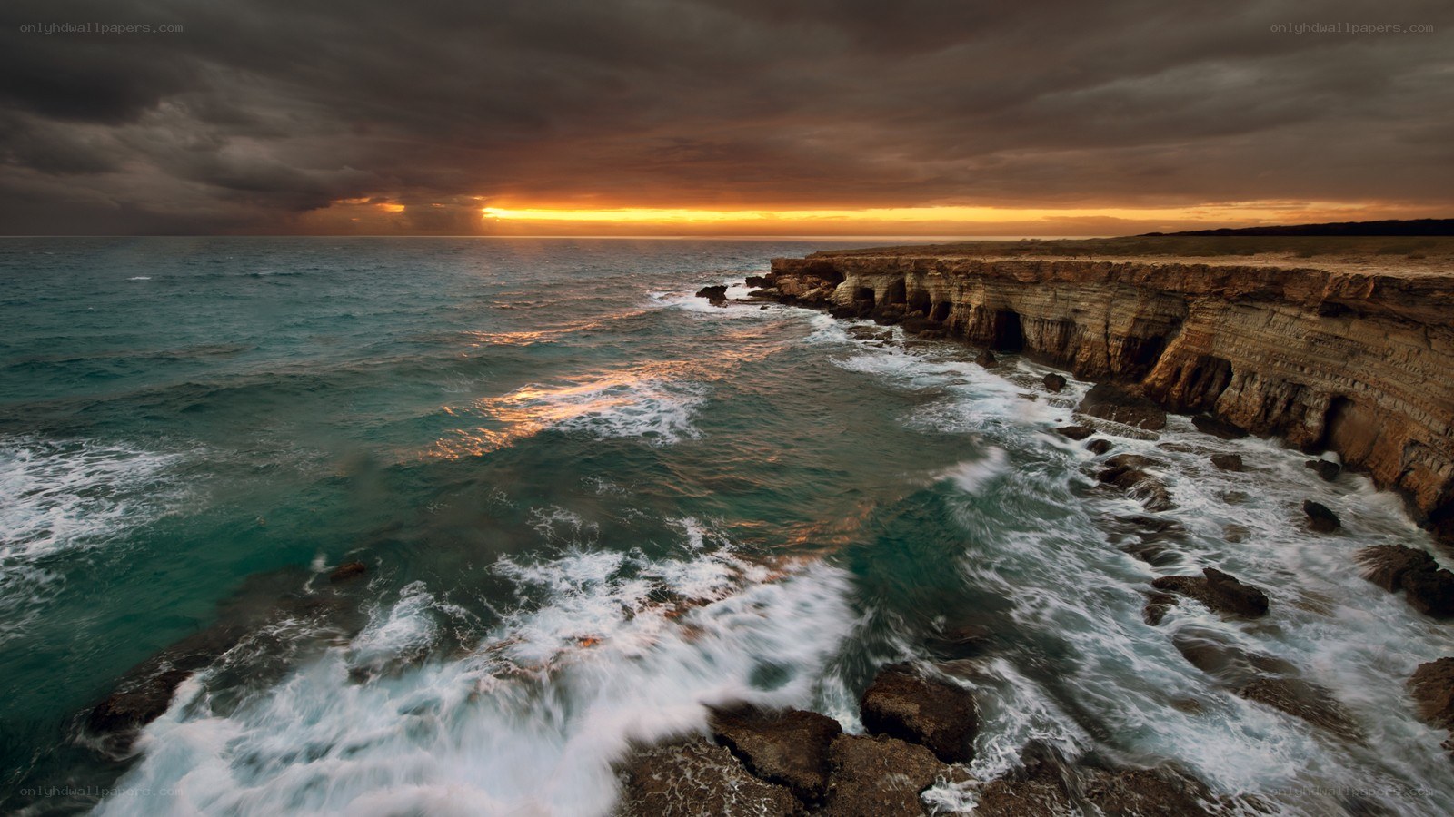 Stormy sunset over coastal cliffs