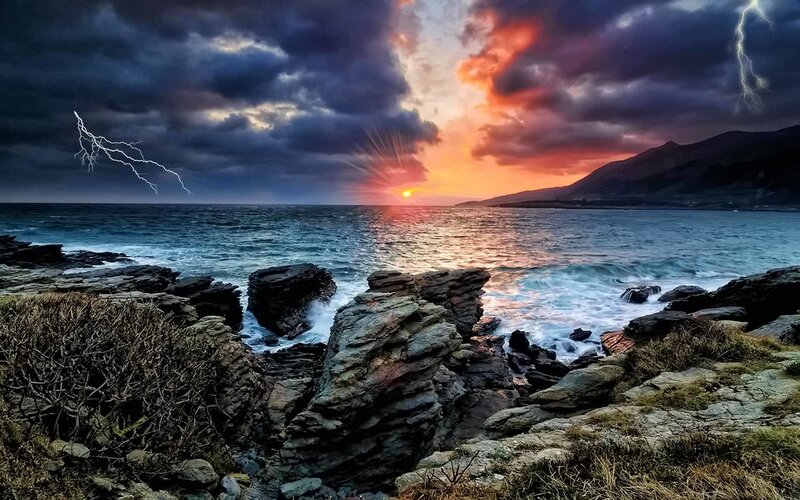 Stormy sunset over rocky coast