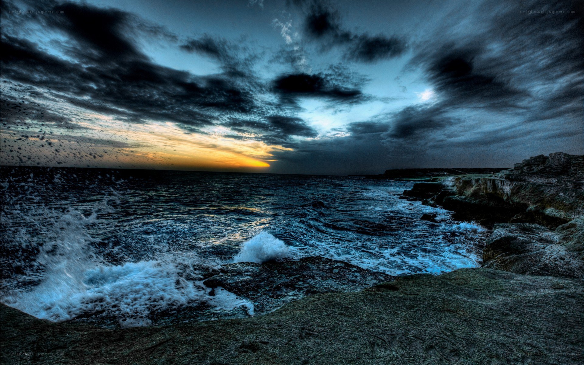 Stormy sunset over rocky coast