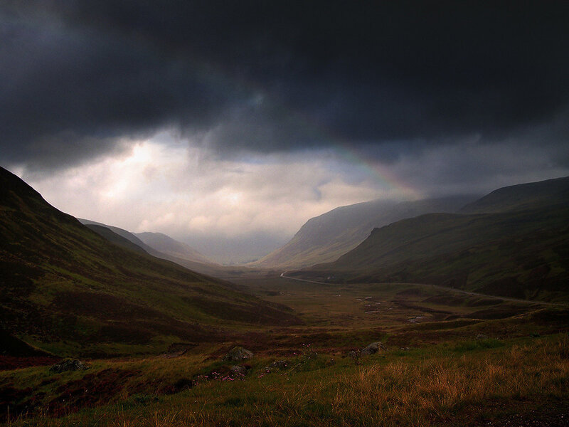 Stormy valley with rainbow