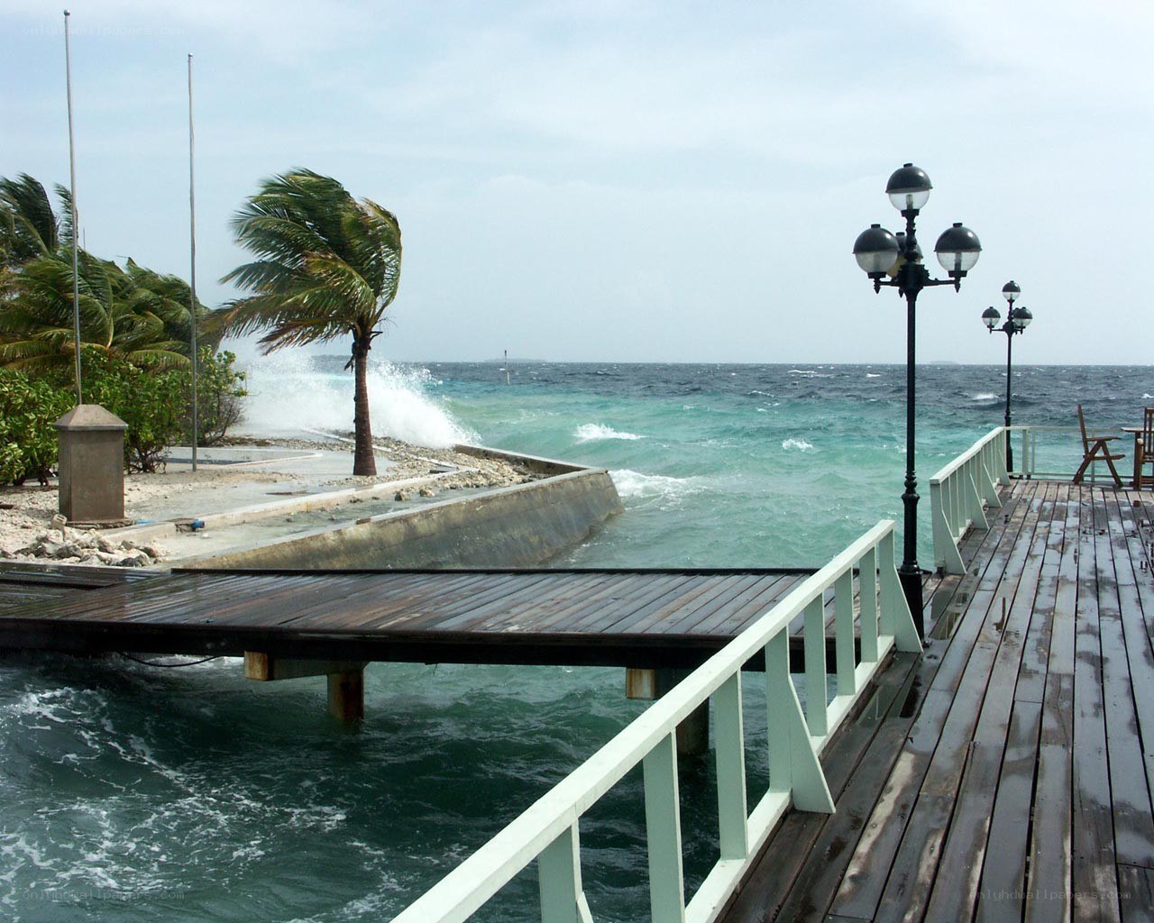 Stormy waves at a tropical pier