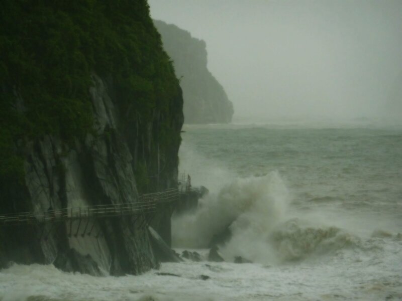 Stormy waves crash against cliffs
