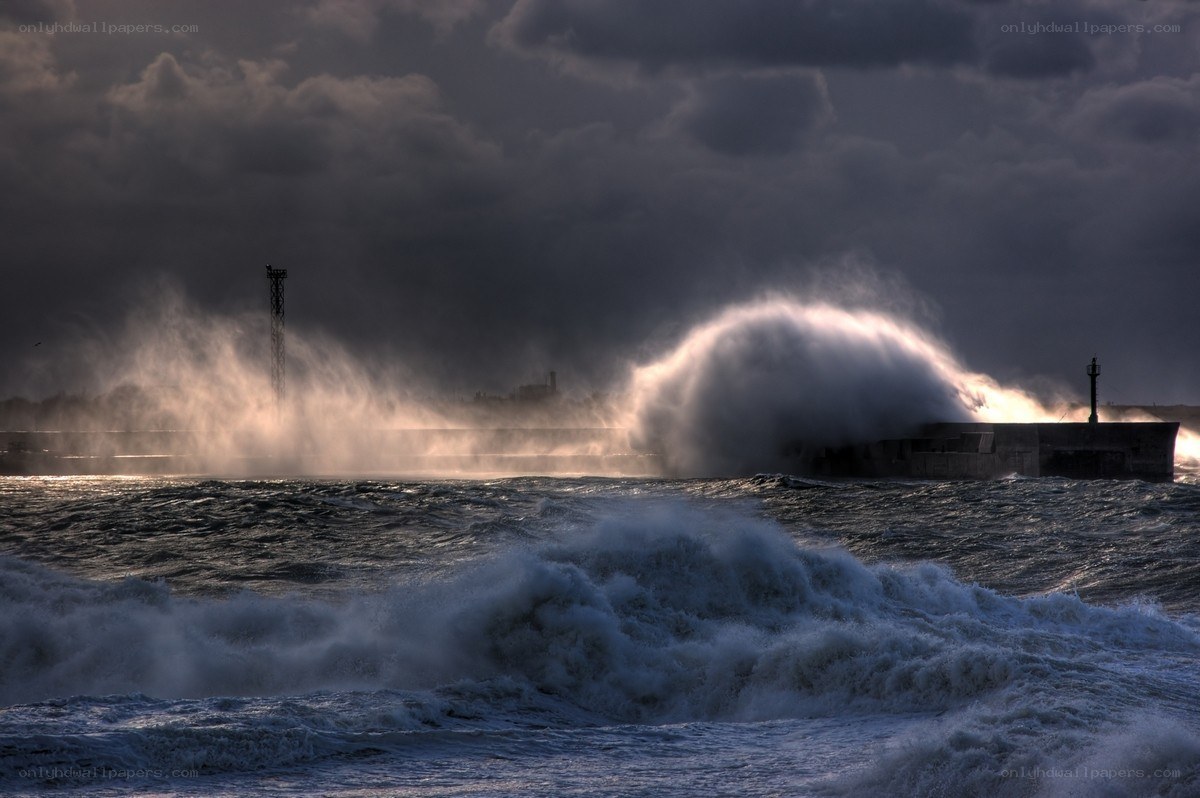 Stormy waves crash on pier