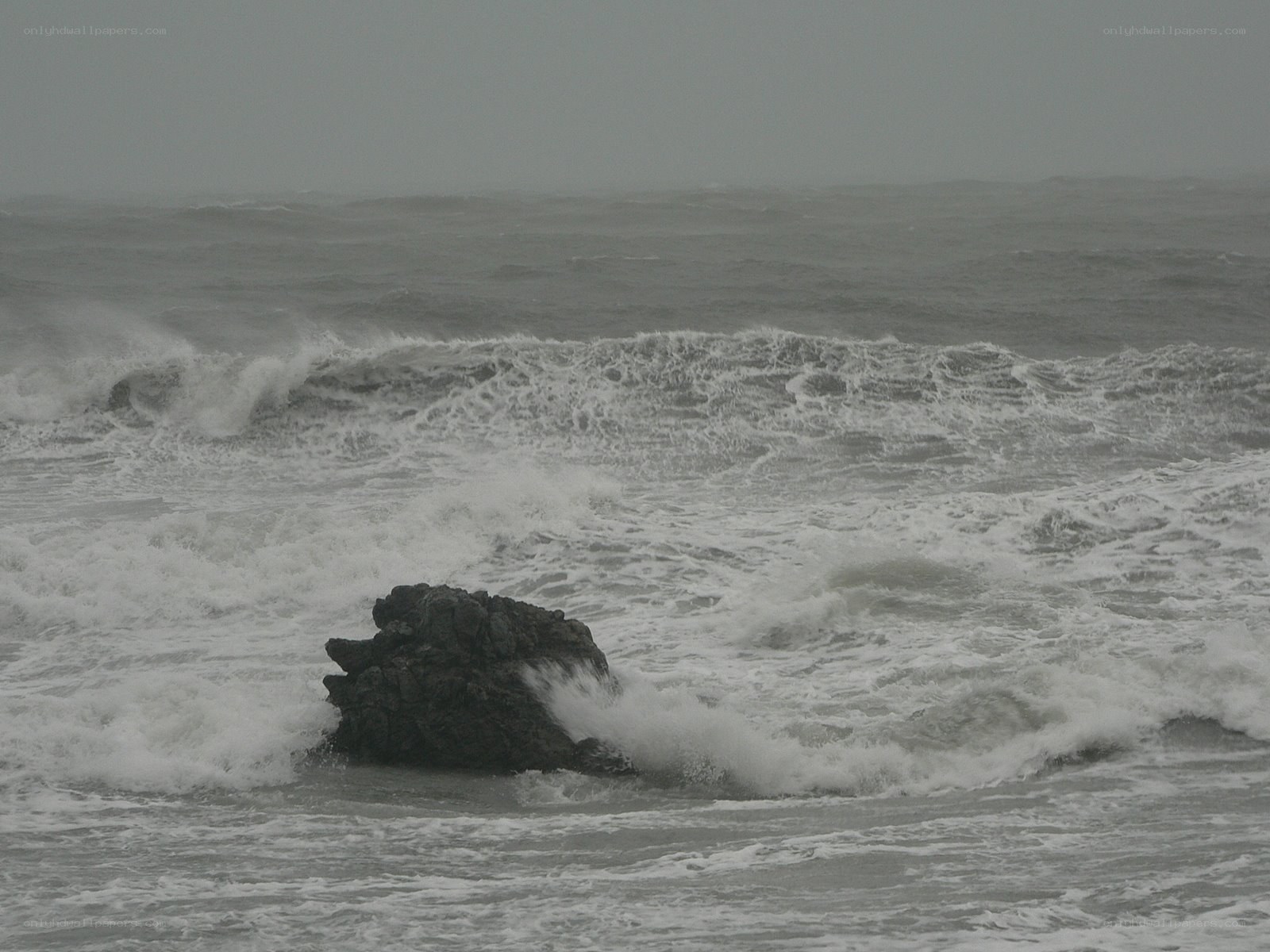 Stormy waves crash on rocks