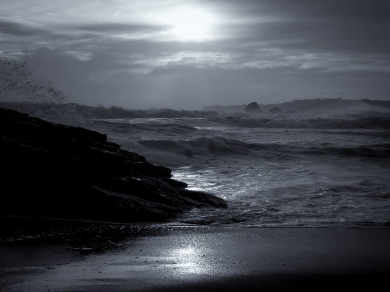 Stormy waves crash on rocky shore